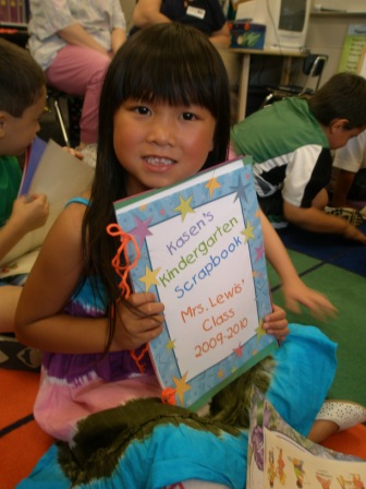 Kasen with her kindergarten scrapbook